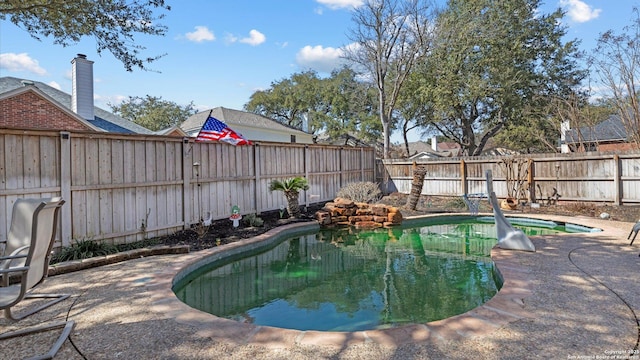 view of swimming pool featuring a fenced backyard and a fenced in pool