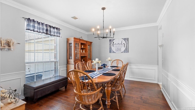 dining room with dark wood-style floors, visible vents, ornamental molding, and an inviting chandelier