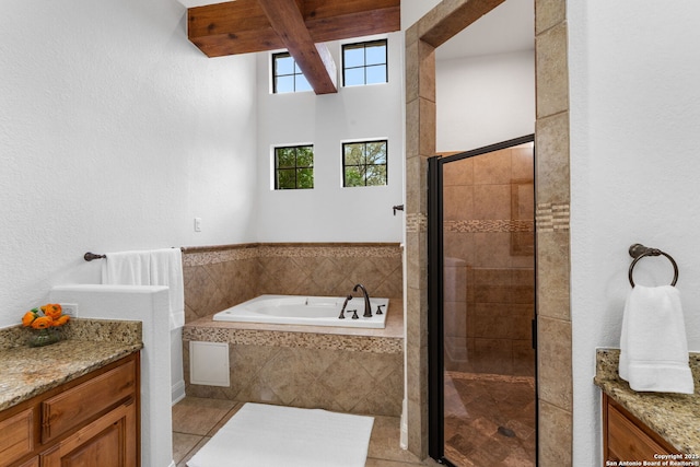 full bathroom featuring a stall shower, a garden tub, vanity, and tile patterned floors