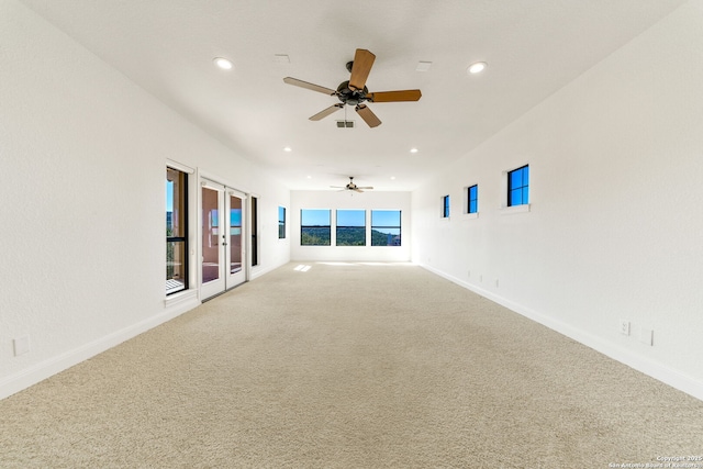 carpeted empty room featuring recessed lighting, baseboards, and french doors