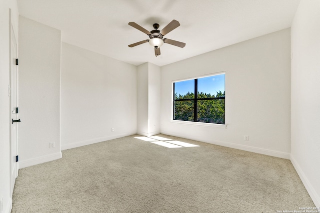 unfurnished room with light carpet, ceiling fan, and baseboards