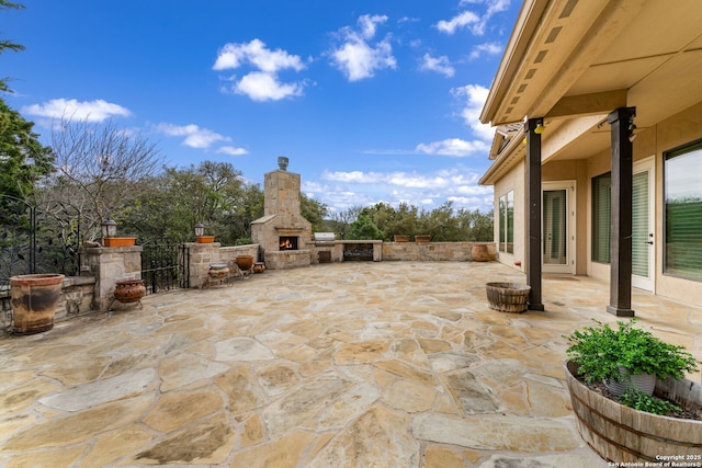 view of patio with an outdoor stone fireplace