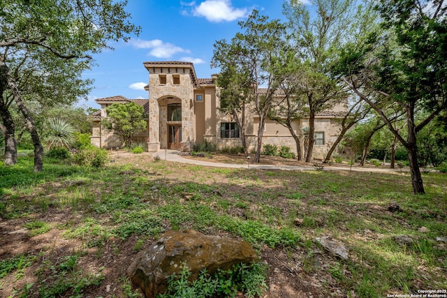 12334 Montel, Helotes, TX 78023 - mediterranean / spanish house with stucco siding, a tiled roof, and stone siding