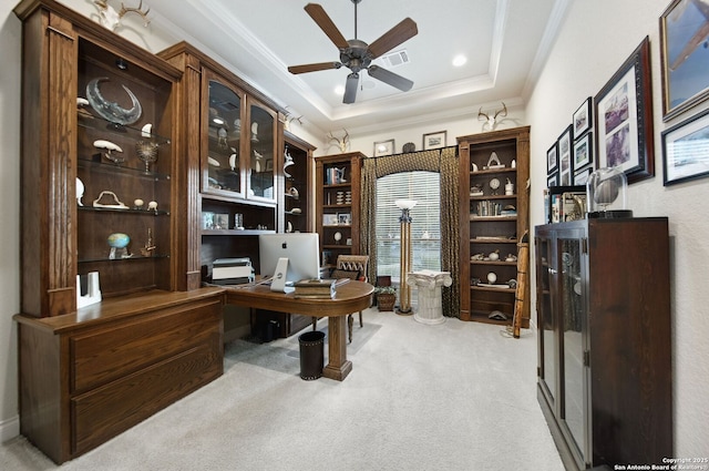 office with light carpet, a raised ceiling, visible vents, and crown molding