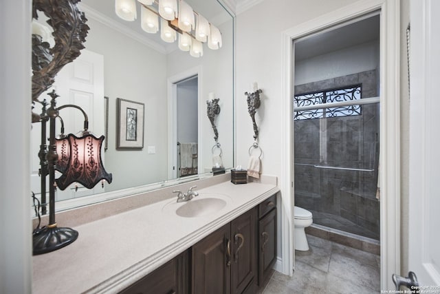 full bathroom featuring toilet, ornamental molding, a stall shower, and vanity