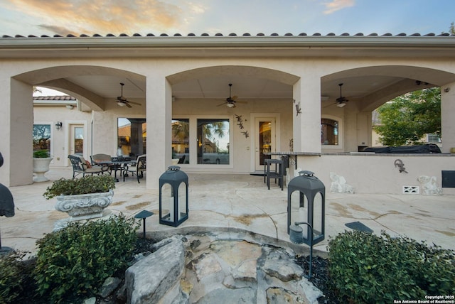 patio terrace at dusk with ceiling fan and outdoor dining area