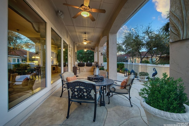 view of patio / terrace with a ceiling fan and fence