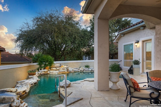 outdoor pool featuring a patio and fence