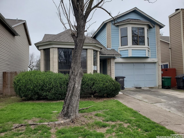 view of front facade with a front lawn, brick siding, driveway, and an attached garage