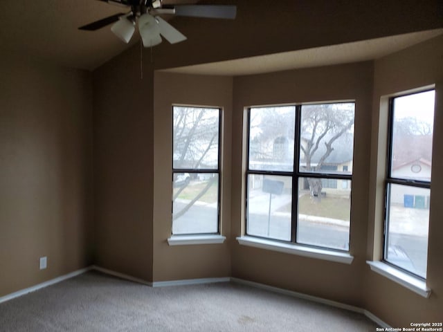 empty room with ceiling fan, baseboards, and light colored carpet