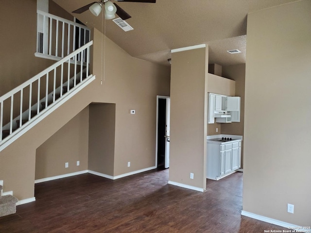 unfurnished living room with dark wood finished floors, visible vents, stairway, ceiling fan, and baseboards