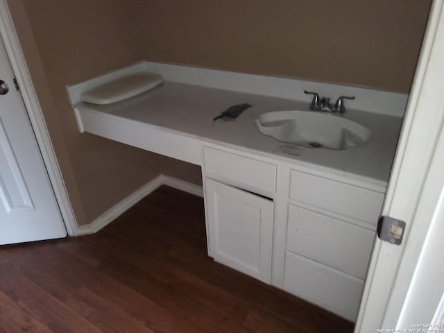 bathroom featuring vanity, baseboards, and wood finished floors