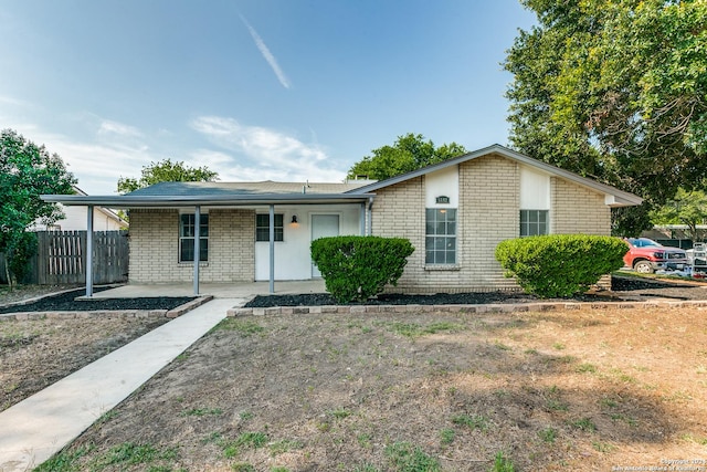 single story home with fence and brick siding