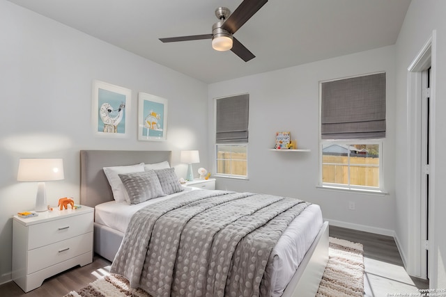 bedroom featuring light wood-style flooring, baseboards, and a ceiling fan