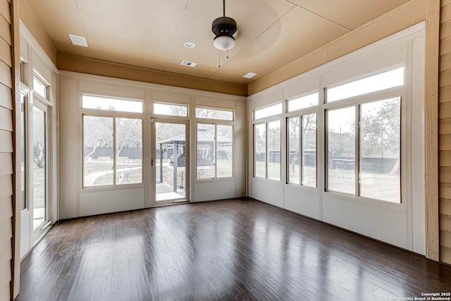 unfurnished sunroom with a ceiling fan