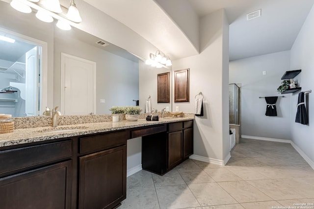 bathroom with visible vents, a sink, and double vanity