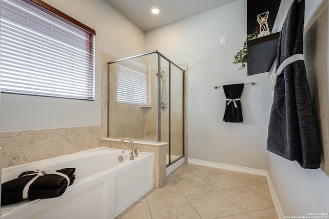 full bath with a stall shower, tile patterned flooring, baseboards, and a bath