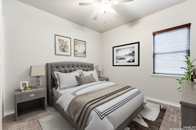 carpeted bedroom featuring baseboards and a ceiling fan