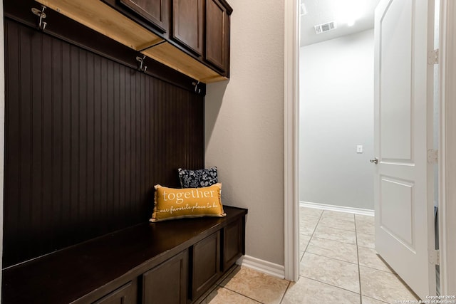 mudroom featuring light tile patterned floors, visible vents, and baseboards