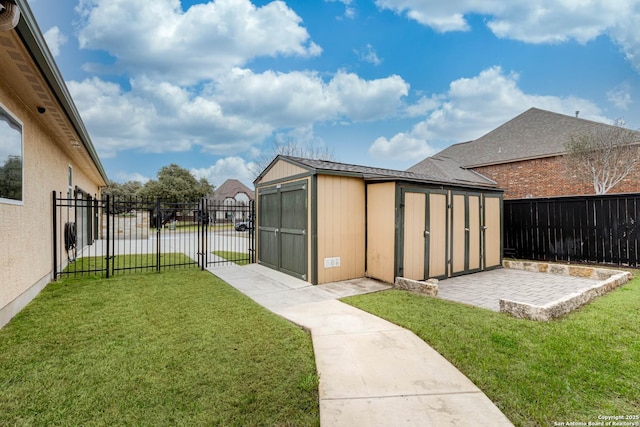 view of yard featuring a fenced backyard, an outdoor structure, a gate, a storage unit, and a patio area