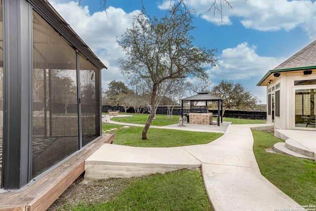 view of yard featuring a patio area, fence, and a gazebo