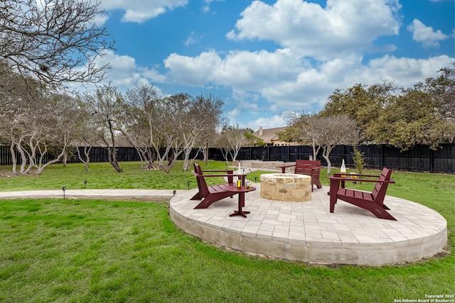 view of home's community with a patio area, a fenced backyard, a fire pit, and a yard