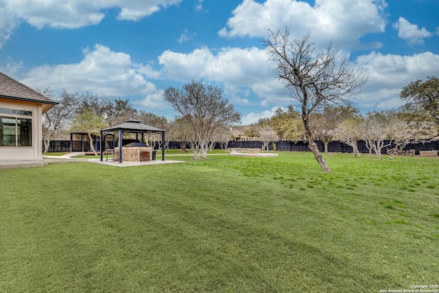 view of yard featuring a fenced backyard and a gazebo