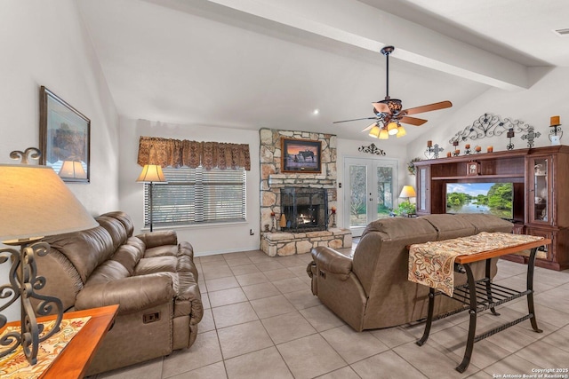 living area with lofted ceiling with beams, light tile patterned floors, a fireplace, and a wealth of natural light