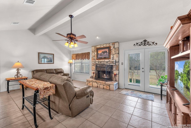 living area with vaulted ceiling with beams, light tile patterned floors, a fireplace, visible vents, and french doors