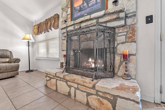 room details with baseboards and a stone fireplace