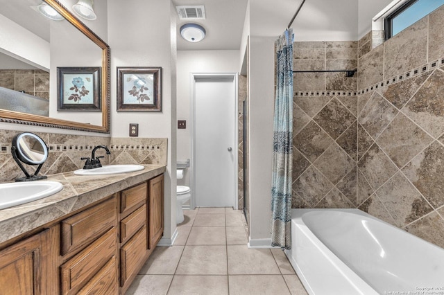 full bath featuring toilet, a sink, visible vents, tile patterned floors, and double vanity