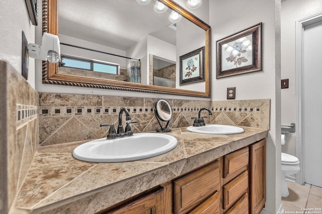 bathroom featuring decorative backsplash, tile patterned flooring, a sink, and toilet