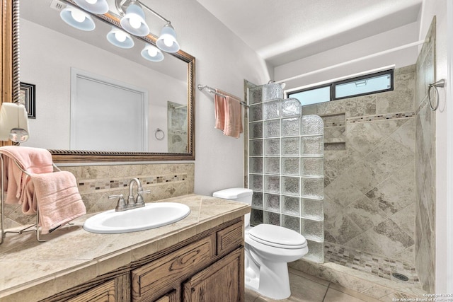 full bath with toilet, tile patterned flooring, walk in shower, vanity, and backsplash