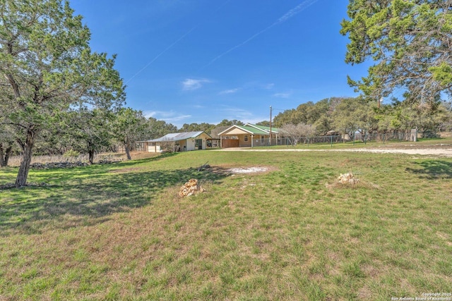 view of yard with a rural view and fence