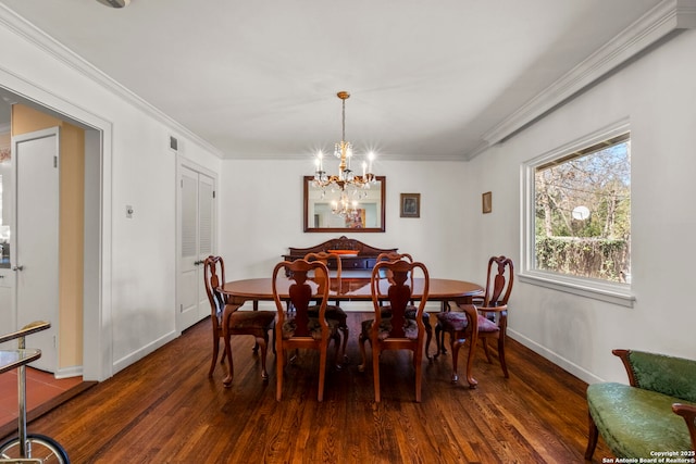 dining area with baseboards, ornamental molding, and wood finished floors