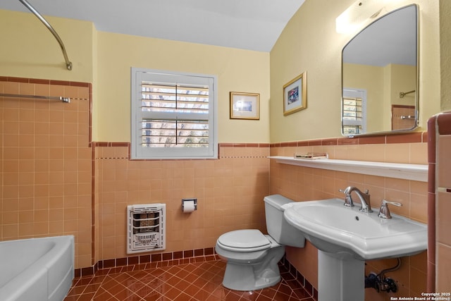 bathroom with a healthy amount of sunlight, tile patterned flooring, toilet, and heating unit