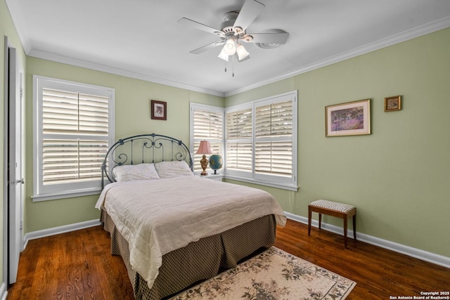 bedroom with ceiling fan, crown molding, baseboards, and wood finished floors