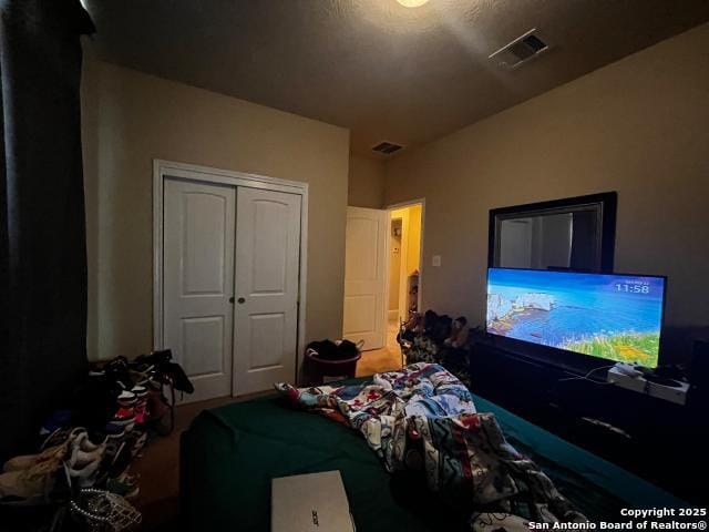 bedroom featuring a closet and visible vents