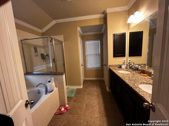 full bath with crown molding, double vanity, a sink, a shower stall, and baseboards