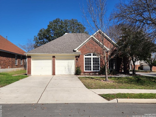 view of front facade featuring an attached garage, brick siding, concrete driveway, roof with shingles, and a front yard