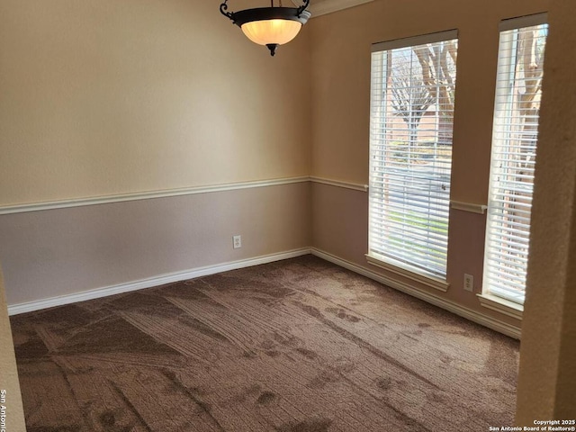 empty room with carpet floors and baseboards