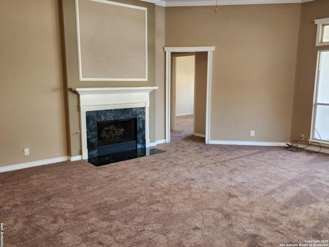 unfurnished living room featuring carpet, a high end fireplace, and baseboards