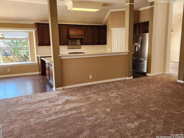 kitchen featuring stainless steel fridge, light countertops, dark brown cabinets, and dark colored carpet