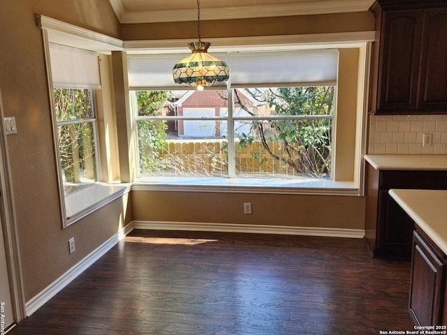 unfurnished dining area with dark wood-style floors, baseboards, and a wealth of natural light