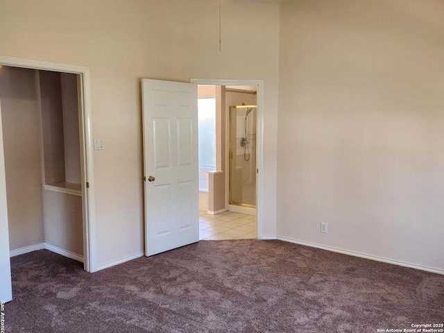 unfurnished bedroom with light carpet and baseboards