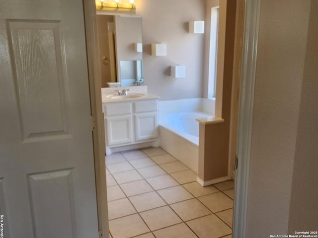 bathroom with vanity, tile patterned flooring, and a bath