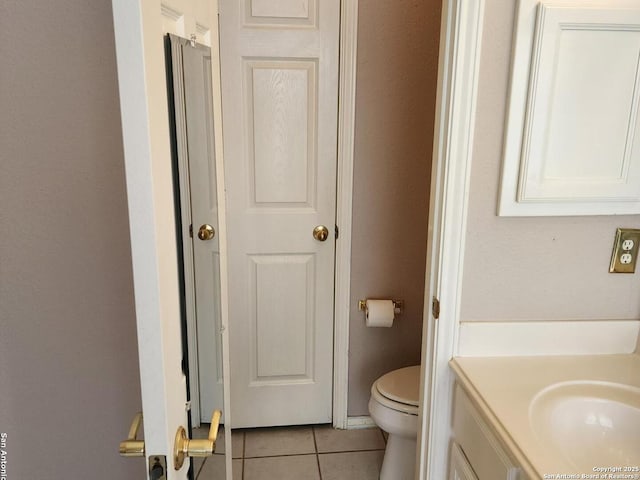 bathroom featuring tile patterned flooring, vanity, and toilet