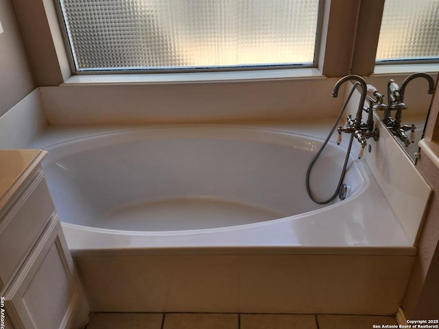 bathroom with vanity and a bath