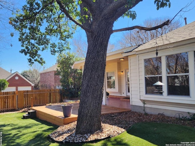 view of yard featuring a deck and fence