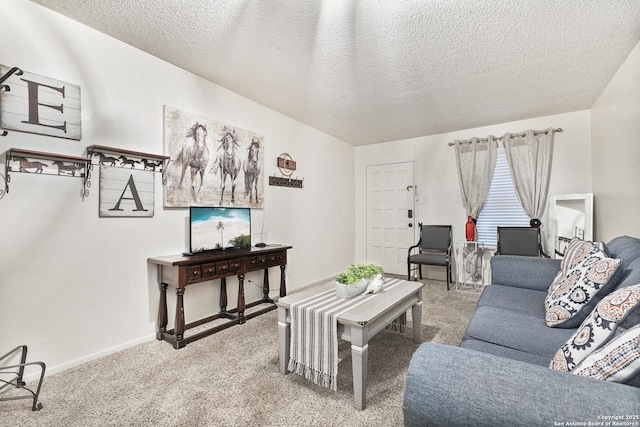 carpeted living room featuring a textured ceiling and baseboards